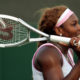 Serena Williams reacts after smashing her racquet