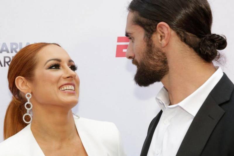 Becky Lynch smiles to seth Rollins
