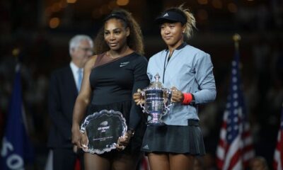 Naomi Osaka lifting US Open tropy with the runner up winner Serena Williams