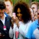 Serena Williams taking a picture of Tiger Woods