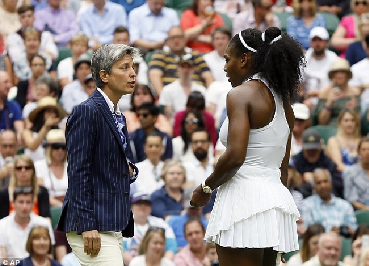 Serena Williams speaks with the umpire Marija Cicak asking if they can close the roof on Centre Court