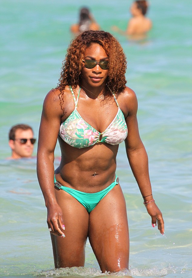 A stunning Serena Williams emerges from the warm waters of Miami Beach in Florida