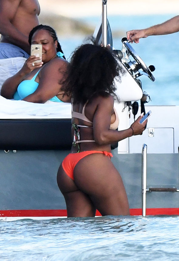 Serena Williams showed off her pert derriere as she hopped on a speedboat.